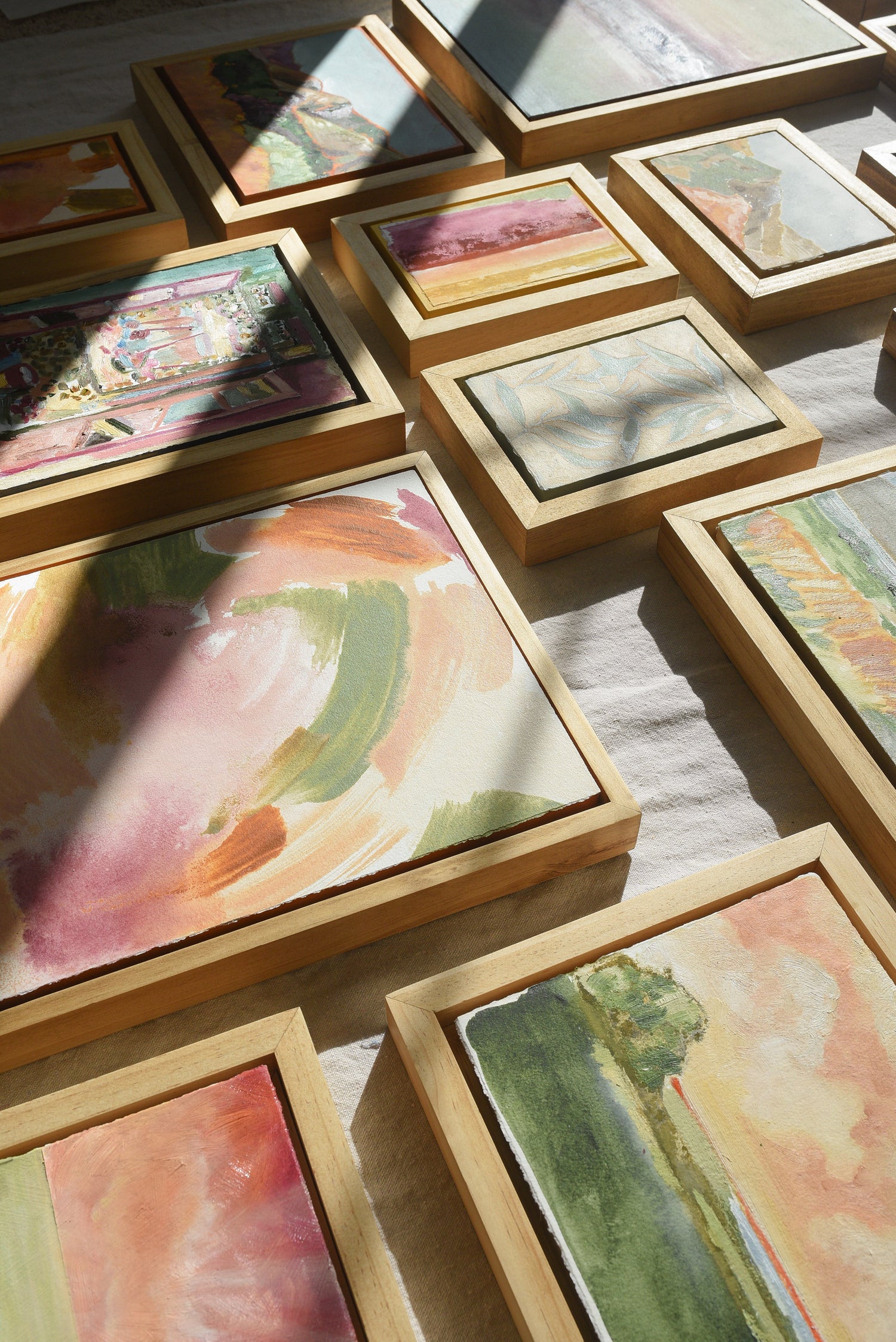 Colorful Display of framed artwork in greens, peaches and yellows