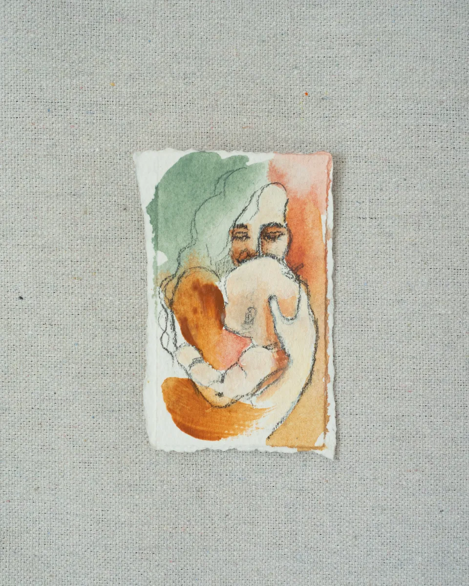 A small painting on torn-edged paper, laid on linen: a long-haired figure drawn in pencil holding a curled baby close, washed in sage green, peach and burnt orange.