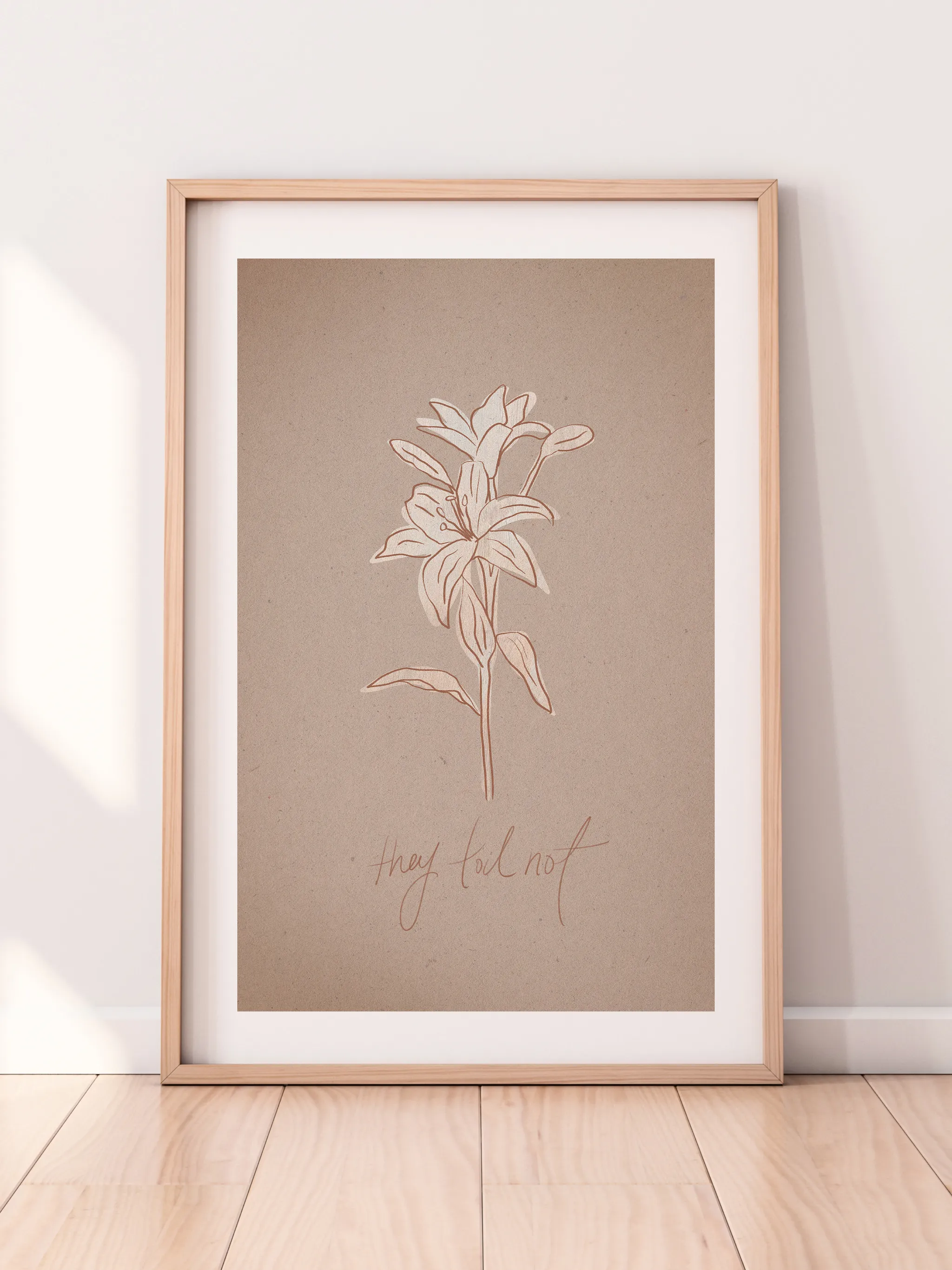 Consider the Lilies on Paper, framed in light wood with a white mat, leaning against a pale wall on a light wood floor.