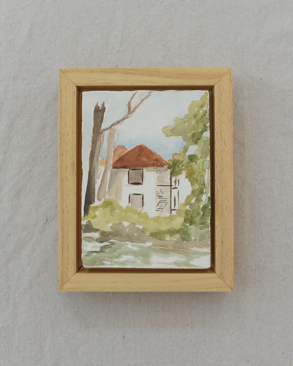 A charming house on the river, surrounded by trees in bright, light tones reminiscent of classic watercolor techniques.