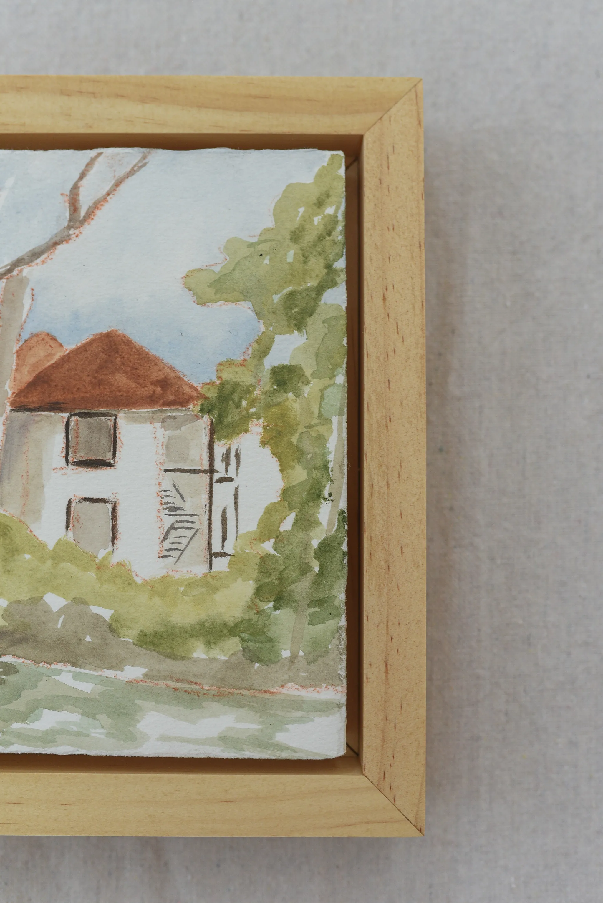 Cottage in the Trees, view 7 of 7: A charming house on the river, surrounded by trees in bright, light tones reminiscent of classic watercolor techniques.
