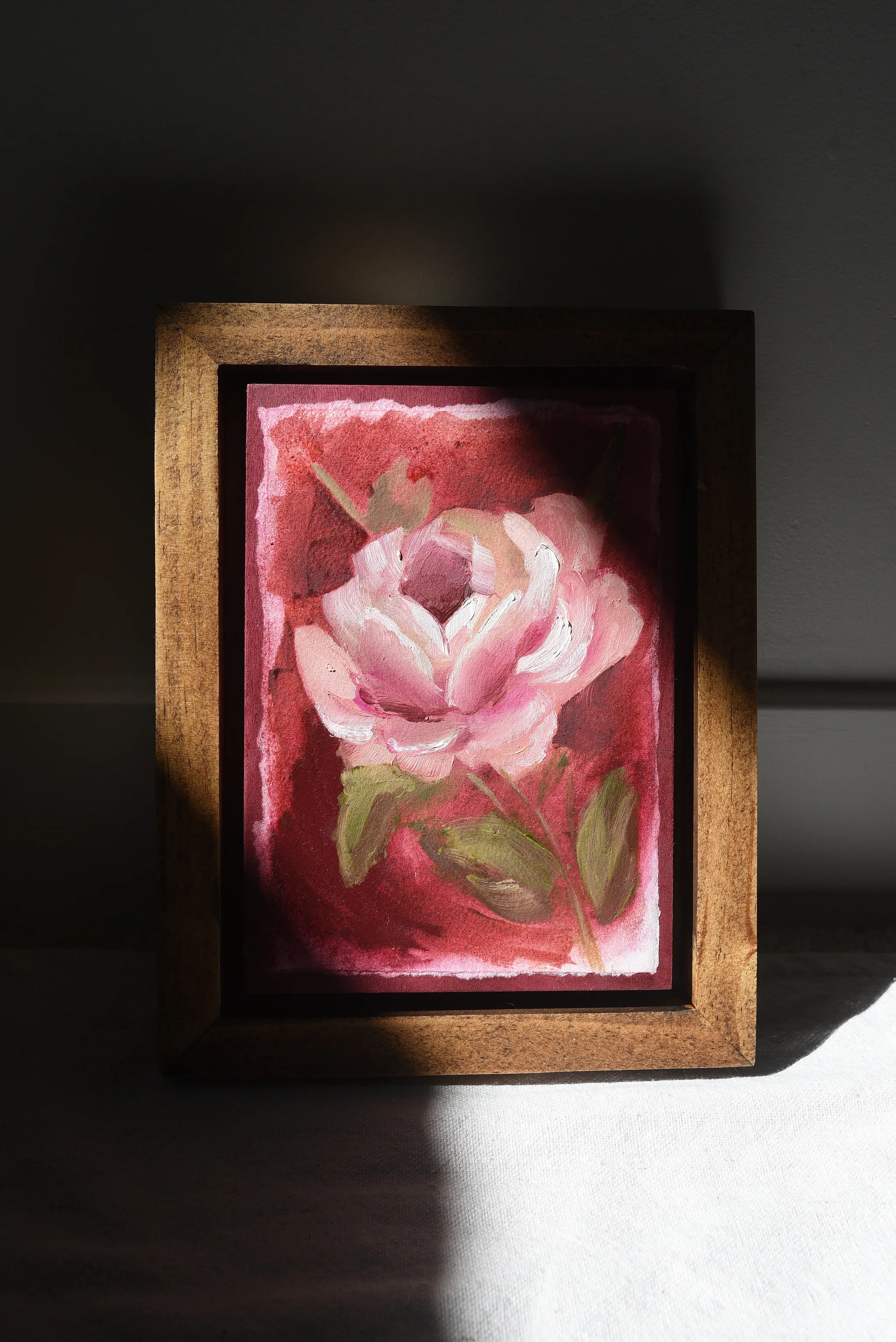 Elegant Bloom, view 4 of 9: A rose blooms against a deep magenta background, rendered in acrylic and oil on paper.