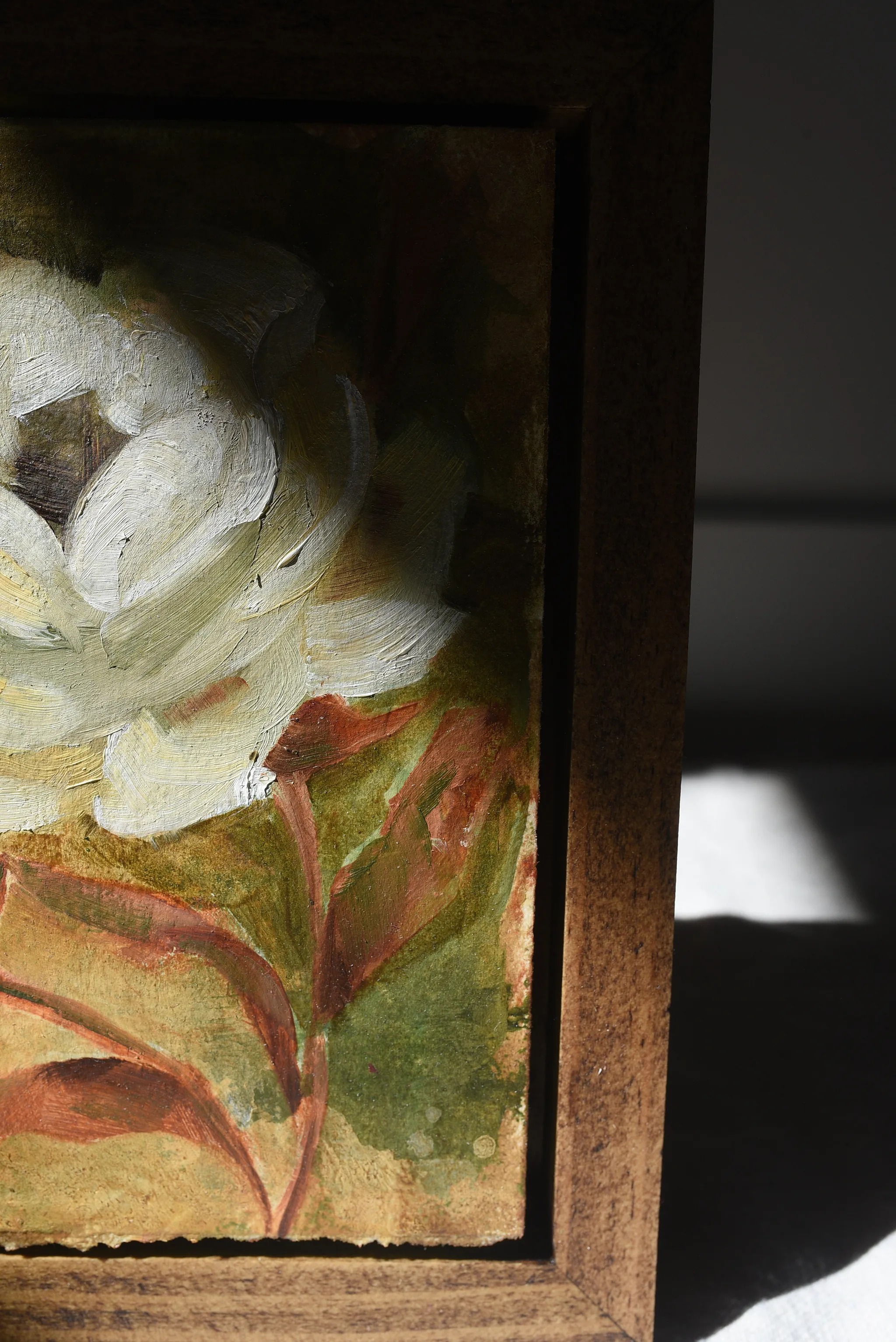 Enduring Bloom, view 4 of 9: A creamy white rose against a warm green and soft yellow background, showcasing rich texture and depth through subtle color shifts.
