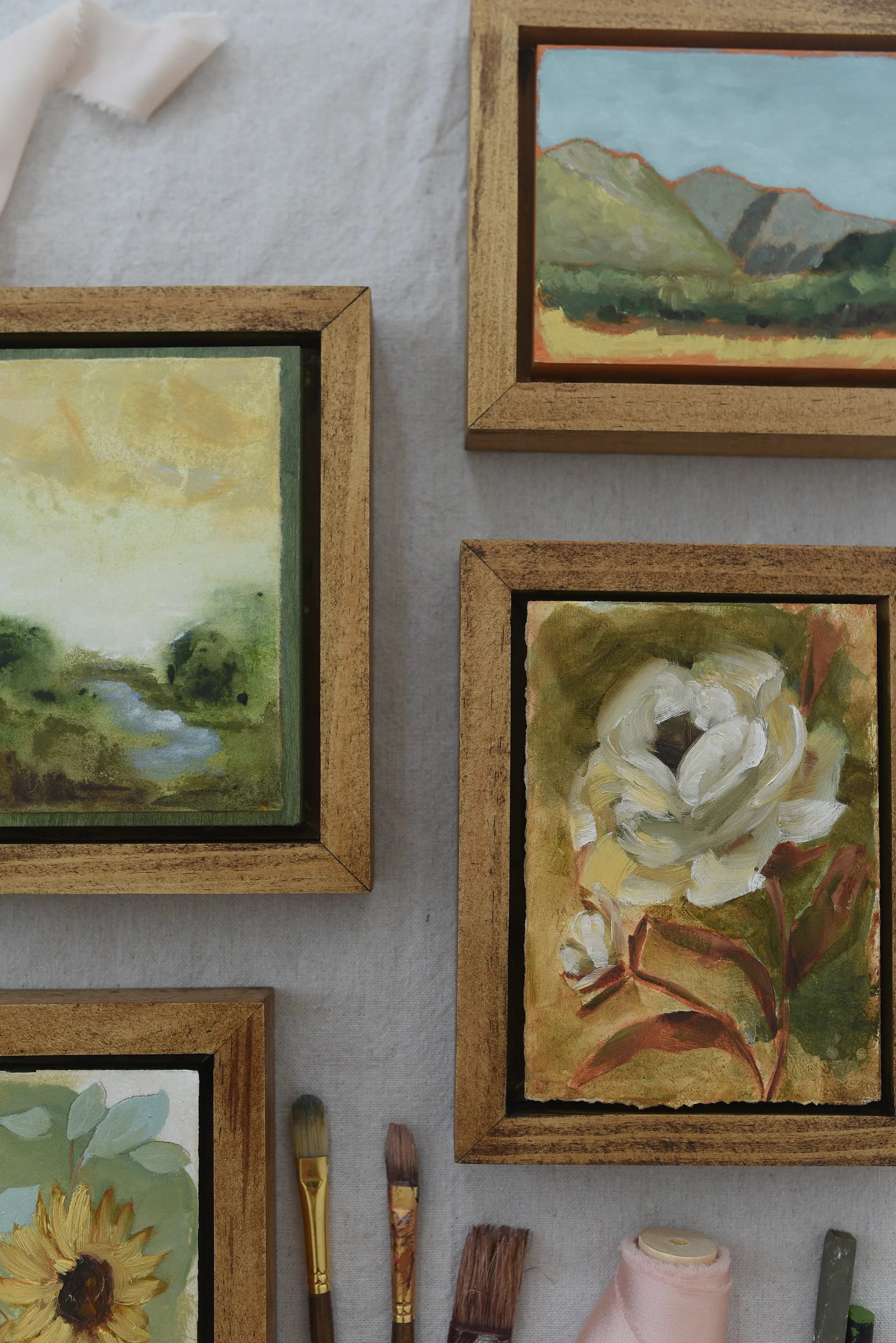 Enduring Bloom, view 6 of 9: A creamy white rose against a warm green and soft yellow background, showcasing rich texture and depth through subtle color shifts.