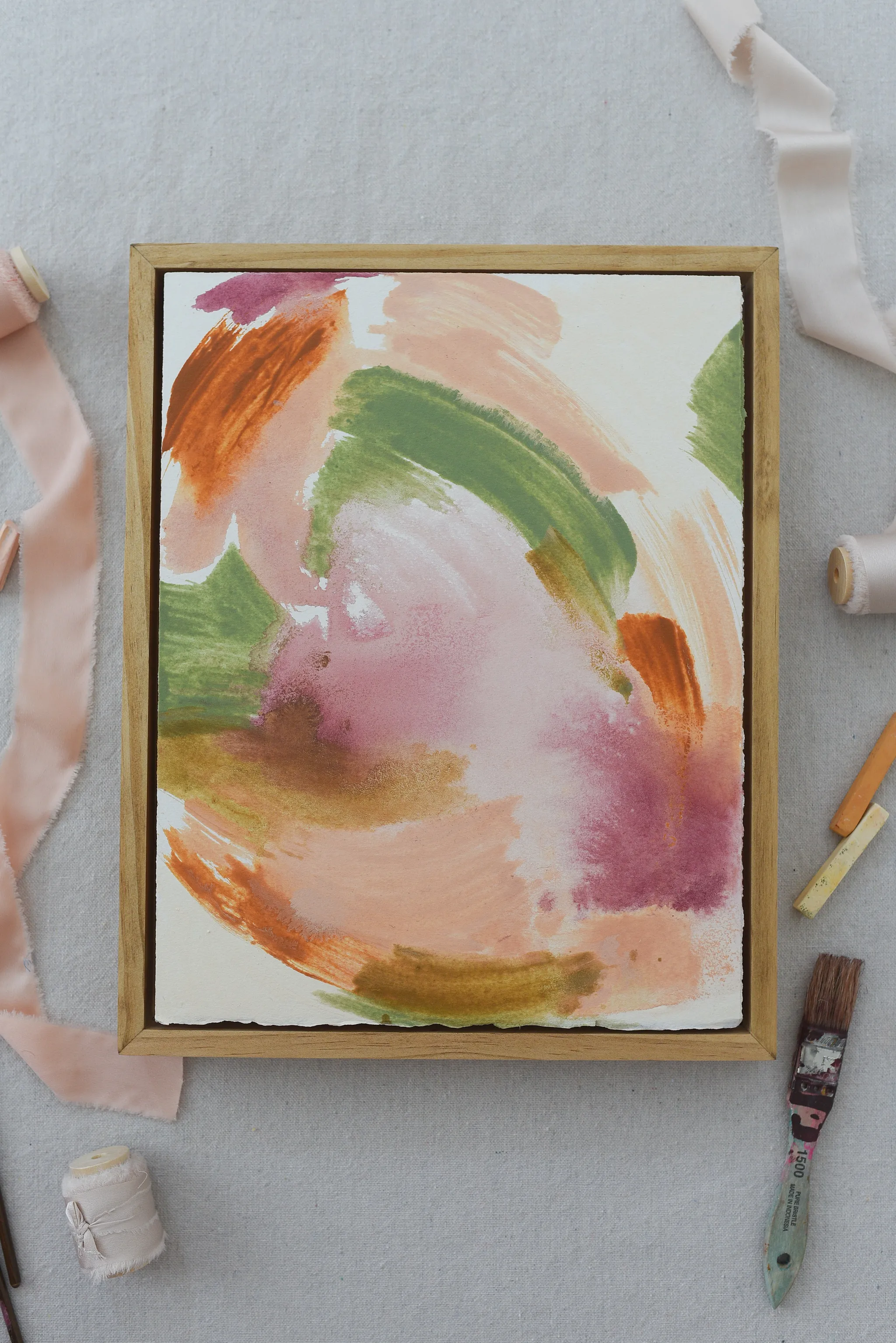 **Frolic** embodies the essence of playful expressionism, with vibrant strokes of color swirling in a joyful circular movement across a canvas of white paper.