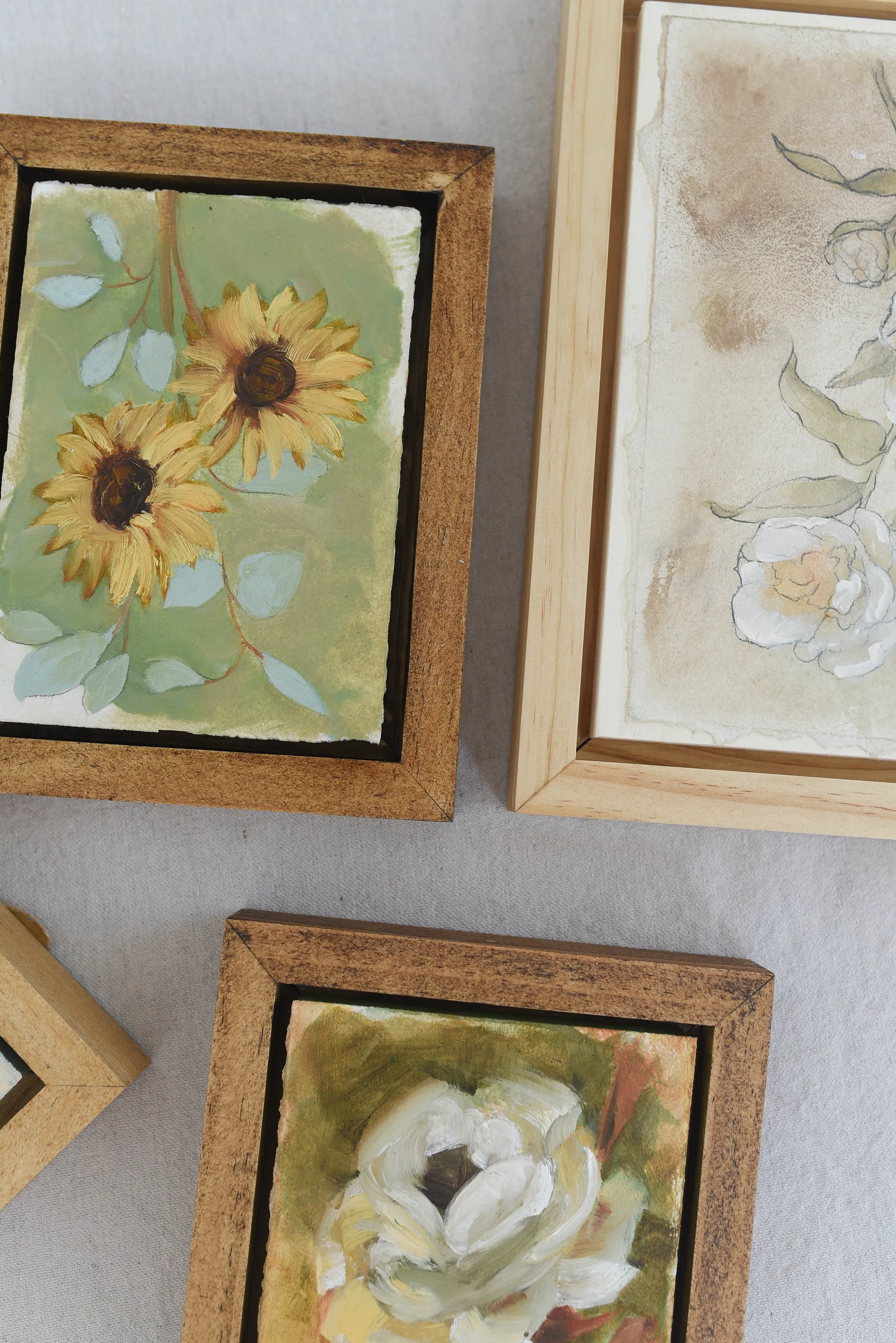 Harmony Bloom, view 10 of 12: three sunflowers radiating warmth against a light green backdrop, interwoven with delicate eucalyptus.