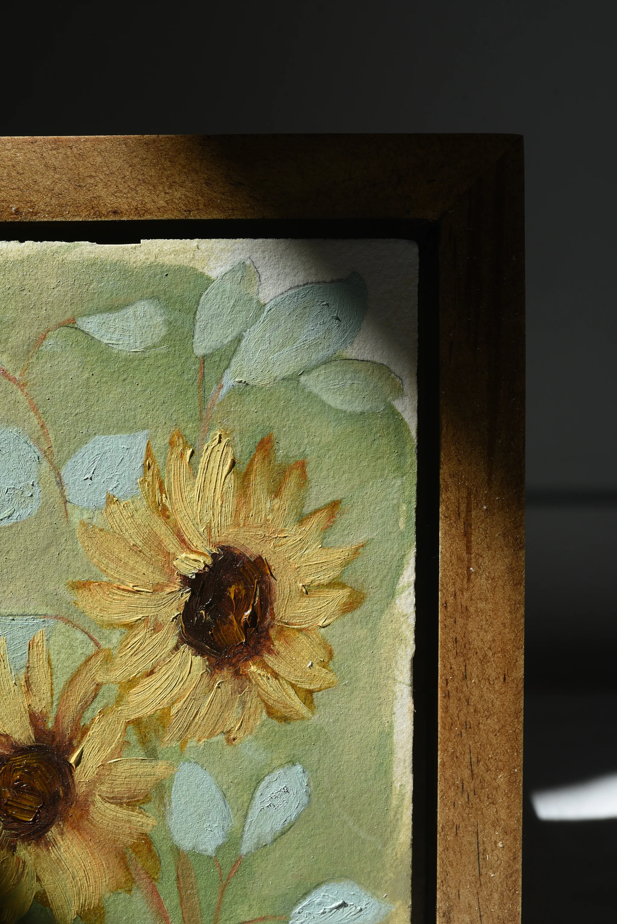 Harmony Bloom, view 5 of 12: three sunflowers radiating warmth against a light green backdrop, interwoven with delicate eucalyptus.