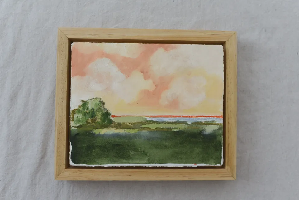**Hope Horizon** presents a vibrant landscape where warm, puffy clouds painted in soft peaches and radiant yellows dance across the sky, casting a golden glow over the lush green.