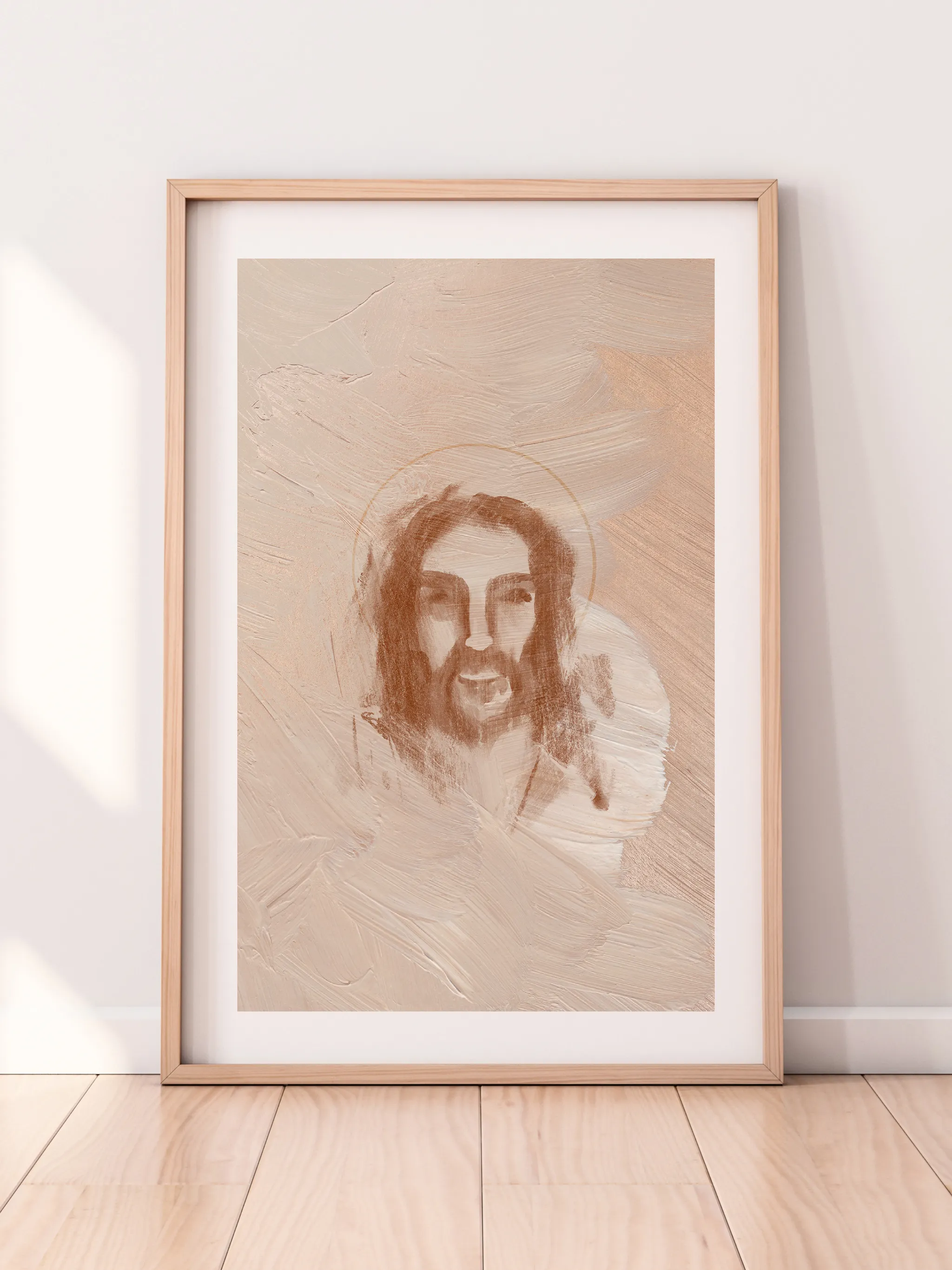 Jesus Portrait Watercolor II, framed in light wood with a white mat, leaning against a pale wall on a light wood floor.