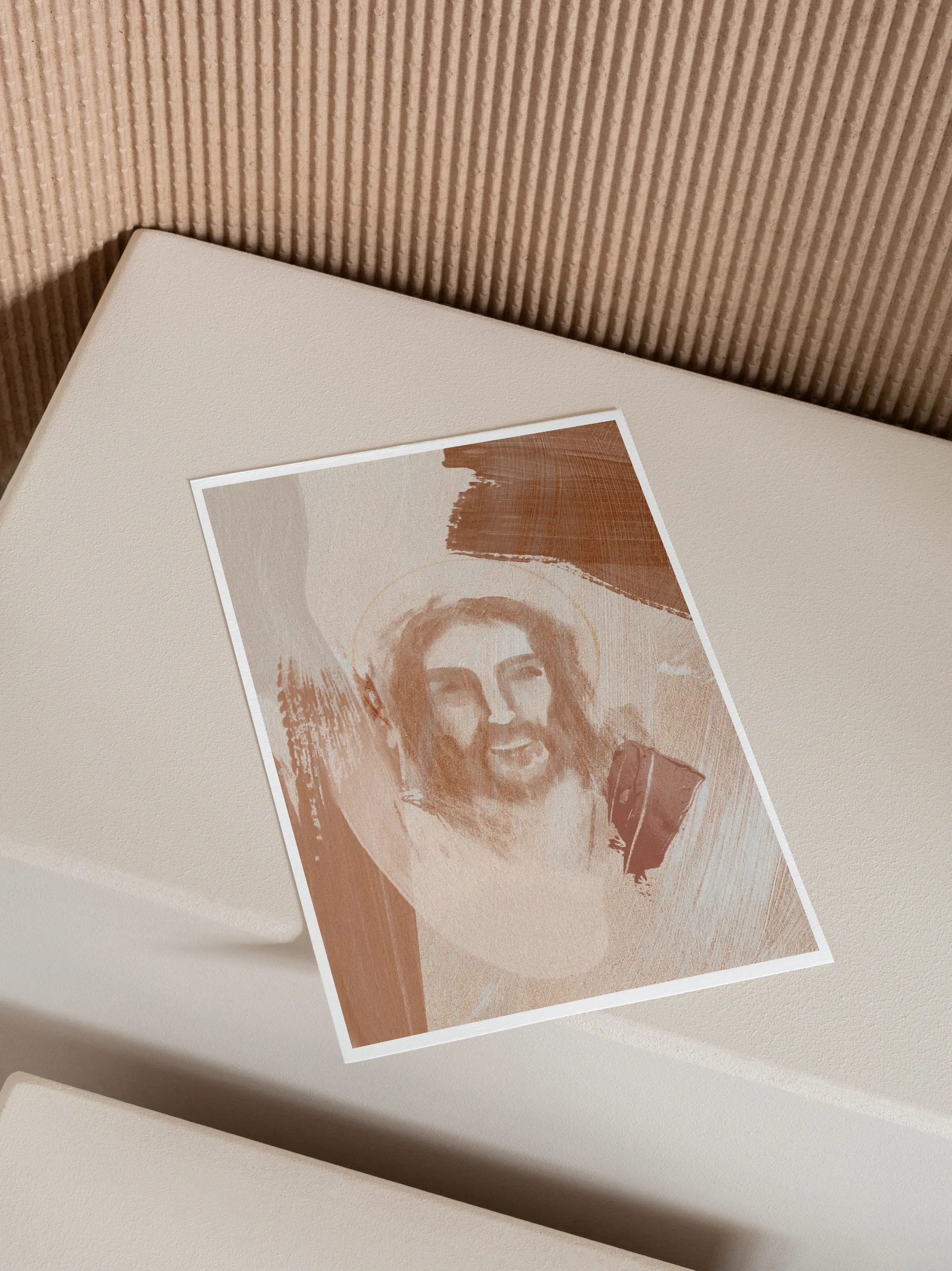 Jesus Portrait Watercolor V, unframed, lying at an angle on a cream box against a ribbed backdrop.