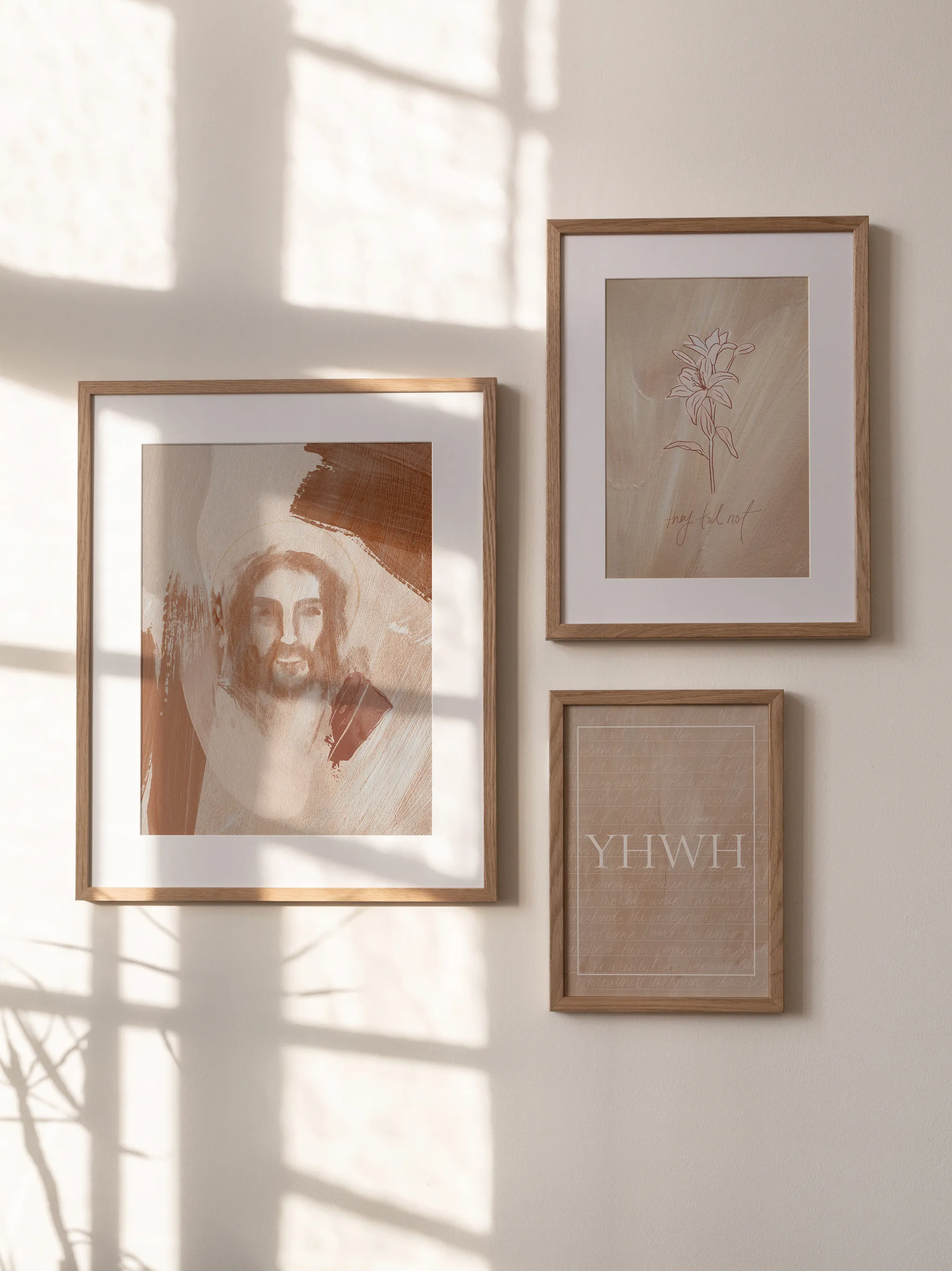Jesus Portrait Watercolor V, framed and hung by a sunlit window in a group of three prints.