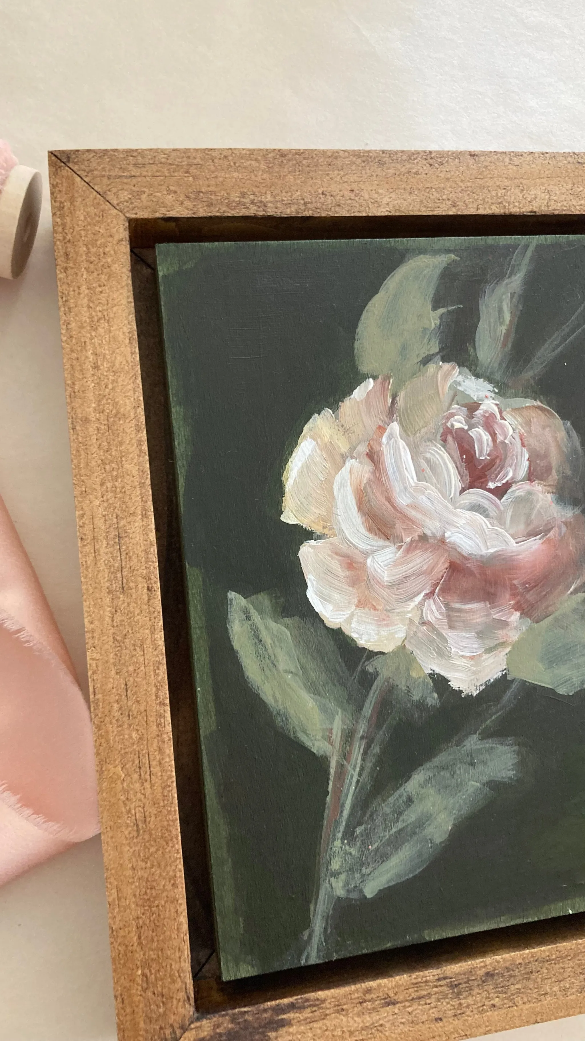Olive Bloom, view 4 of 5: A delicate rose blooms against a dark olive green background, painted in acrylic on raw wood.