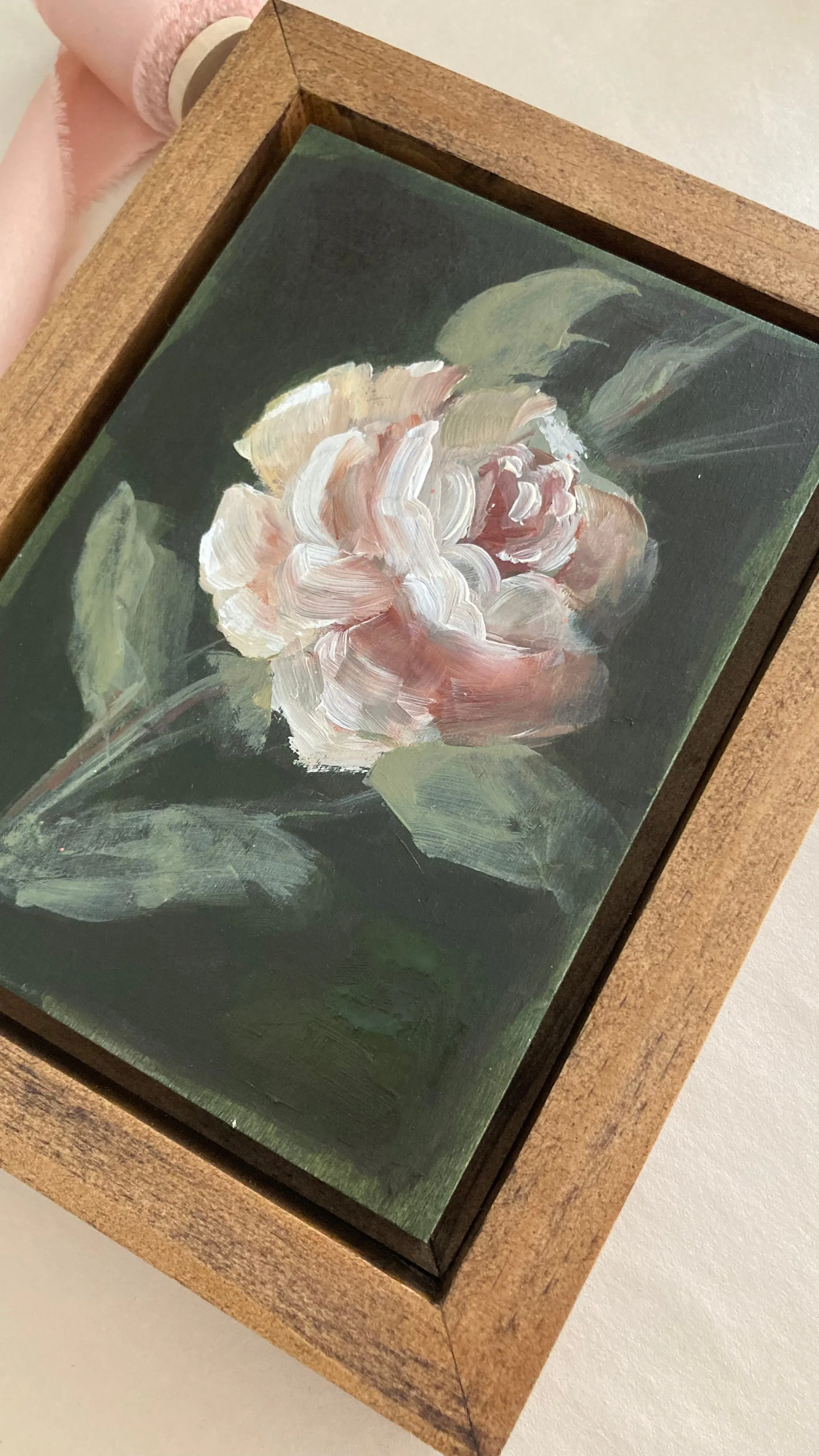 Olive Bloom, view 5 of 5: A delicate rose blooms against a dark olive green background, painted in acrylic on raw wood.
