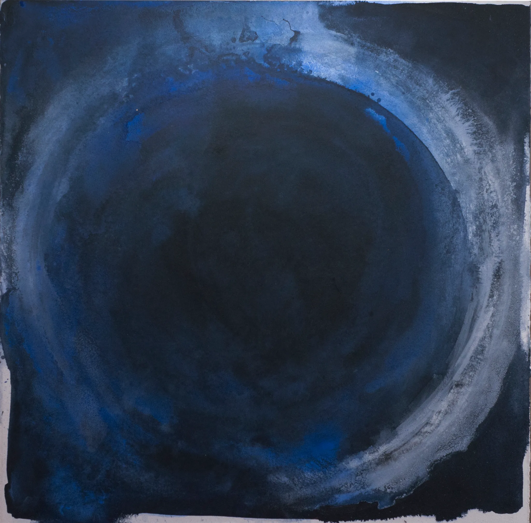 A square painting of a deep indigo circle almost filling the canvas, ringed by a brushed halo of white and pale blue.