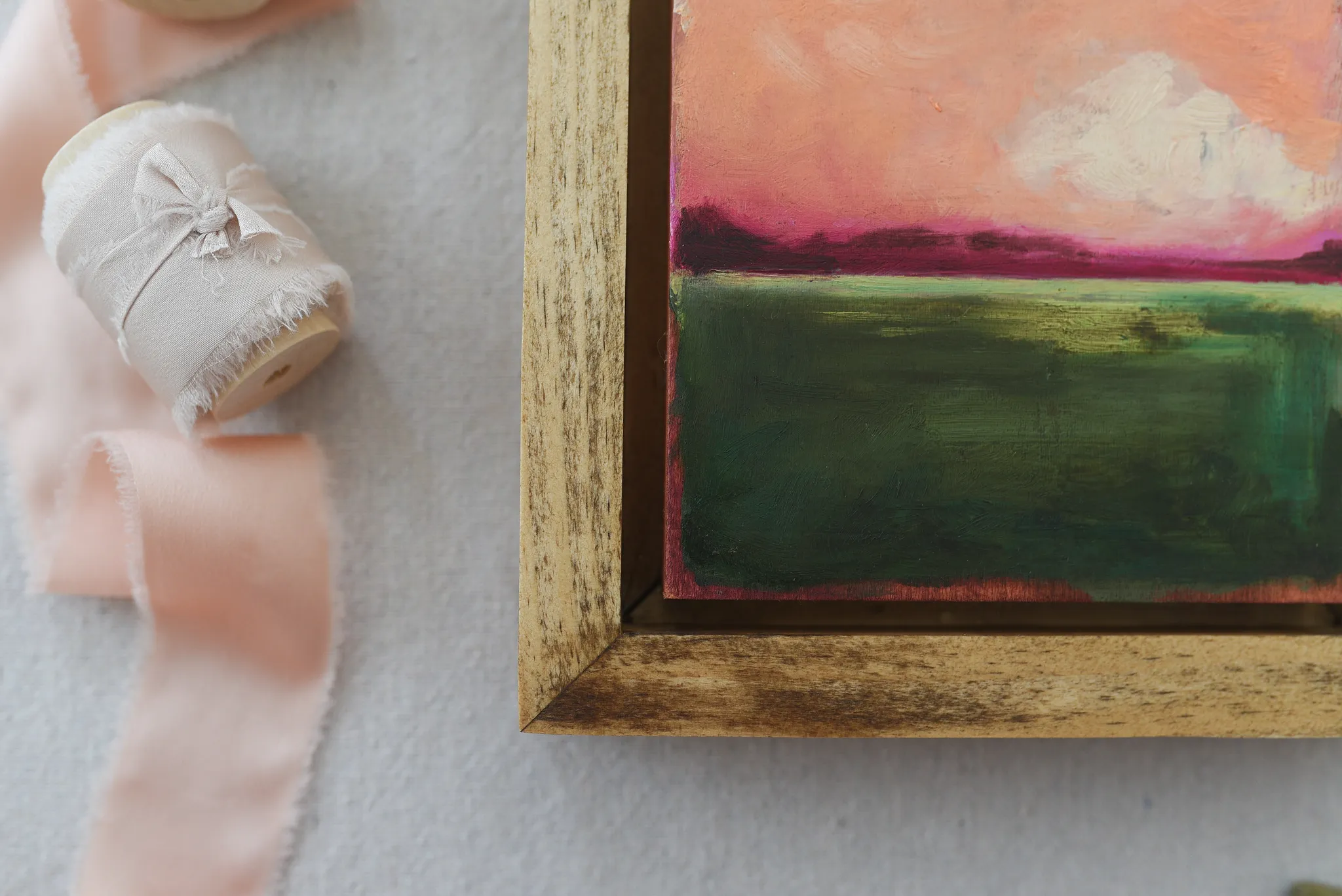 Reverie, view 2 of 12: A striking peach and deep magenta sky adorned with soft clouds, set against a backdrop of deep lush green.