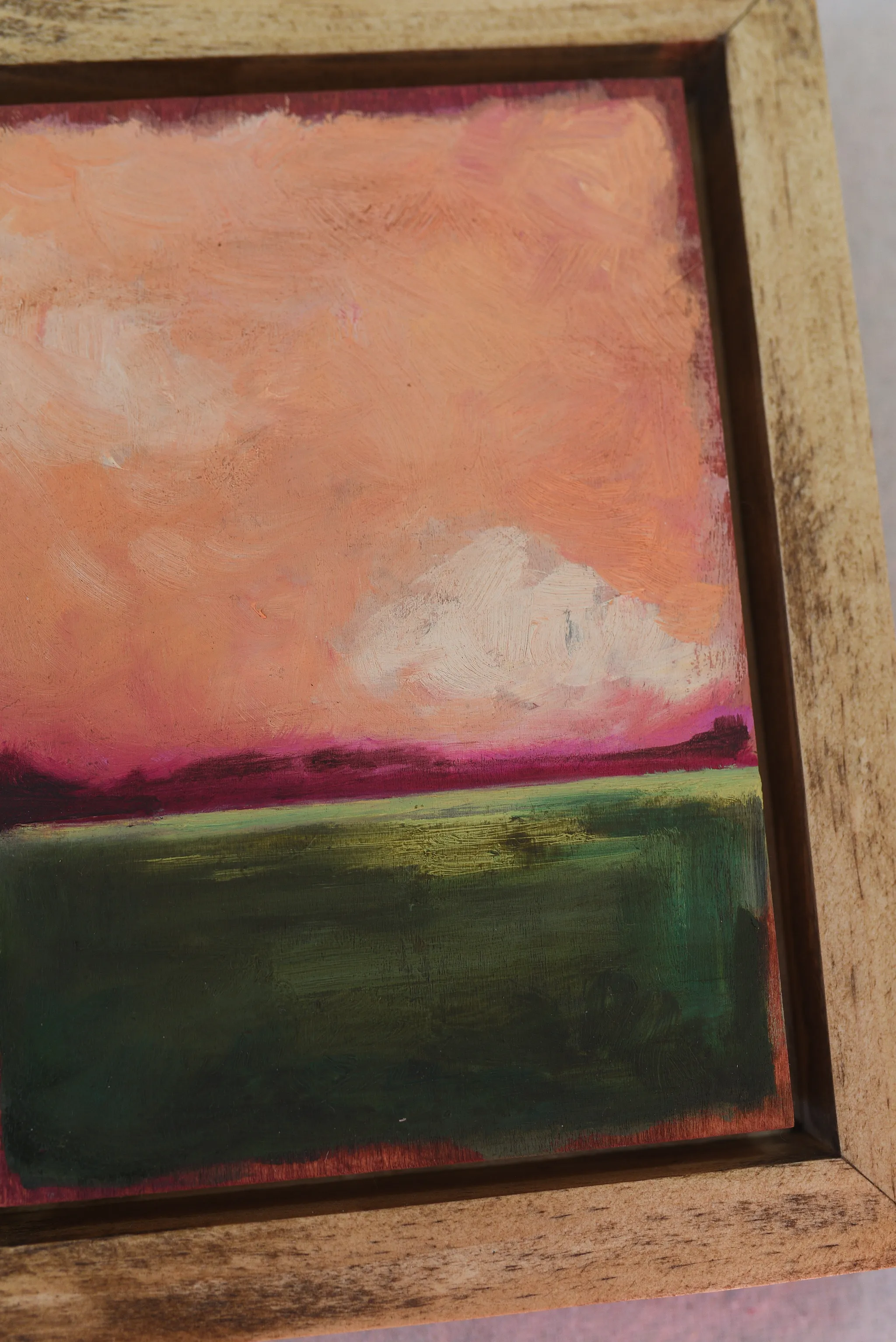 Reverie, view 8 of 12: A striking peach and deep magenta sky adorned with soft clouds, set against a backdrop of deep lush green.