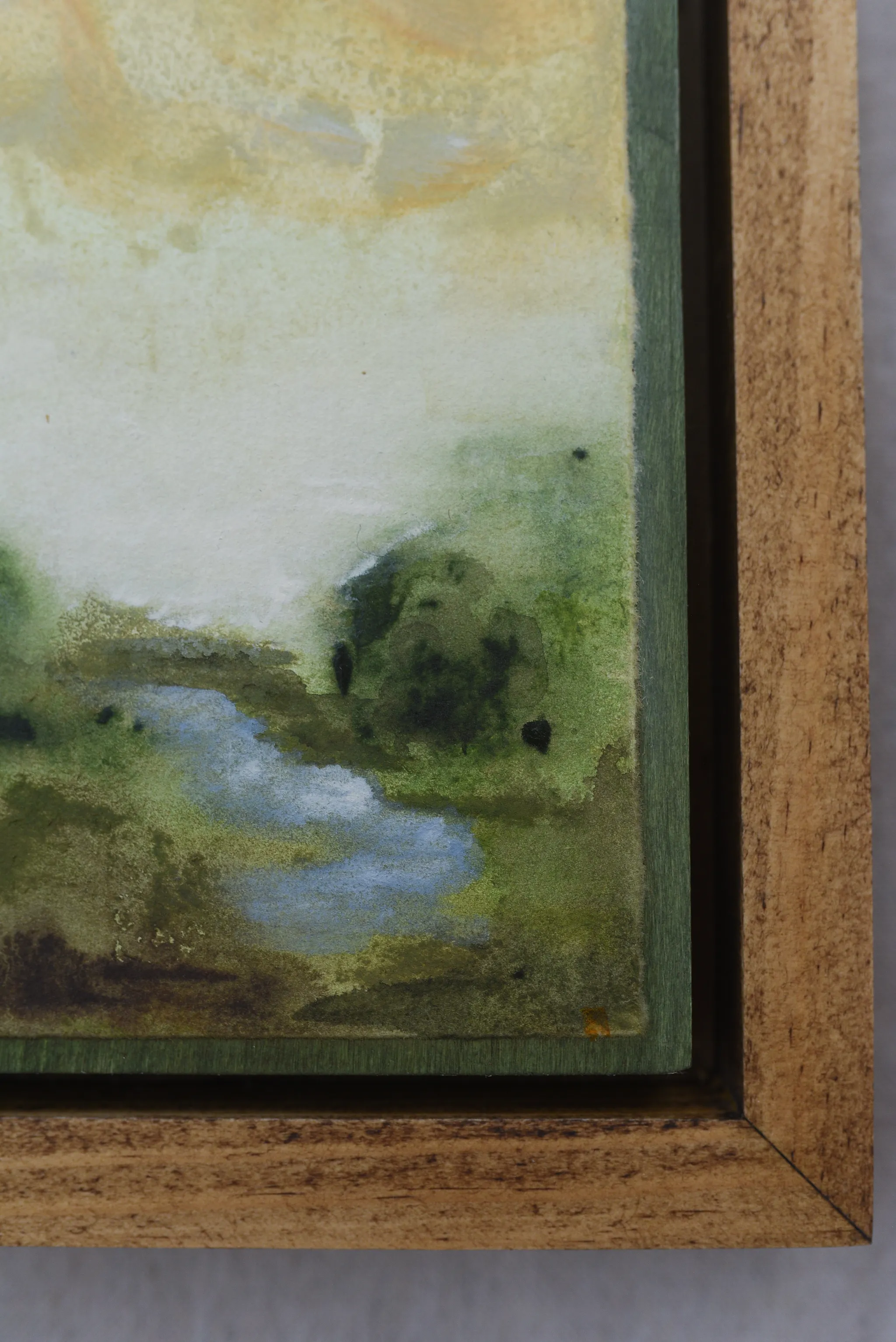 Whispering Stream, view 6 of 9: A moody scene of deep greens contrasted by a soft yellow sky, with a small stream gently wandering through the lush greenery.