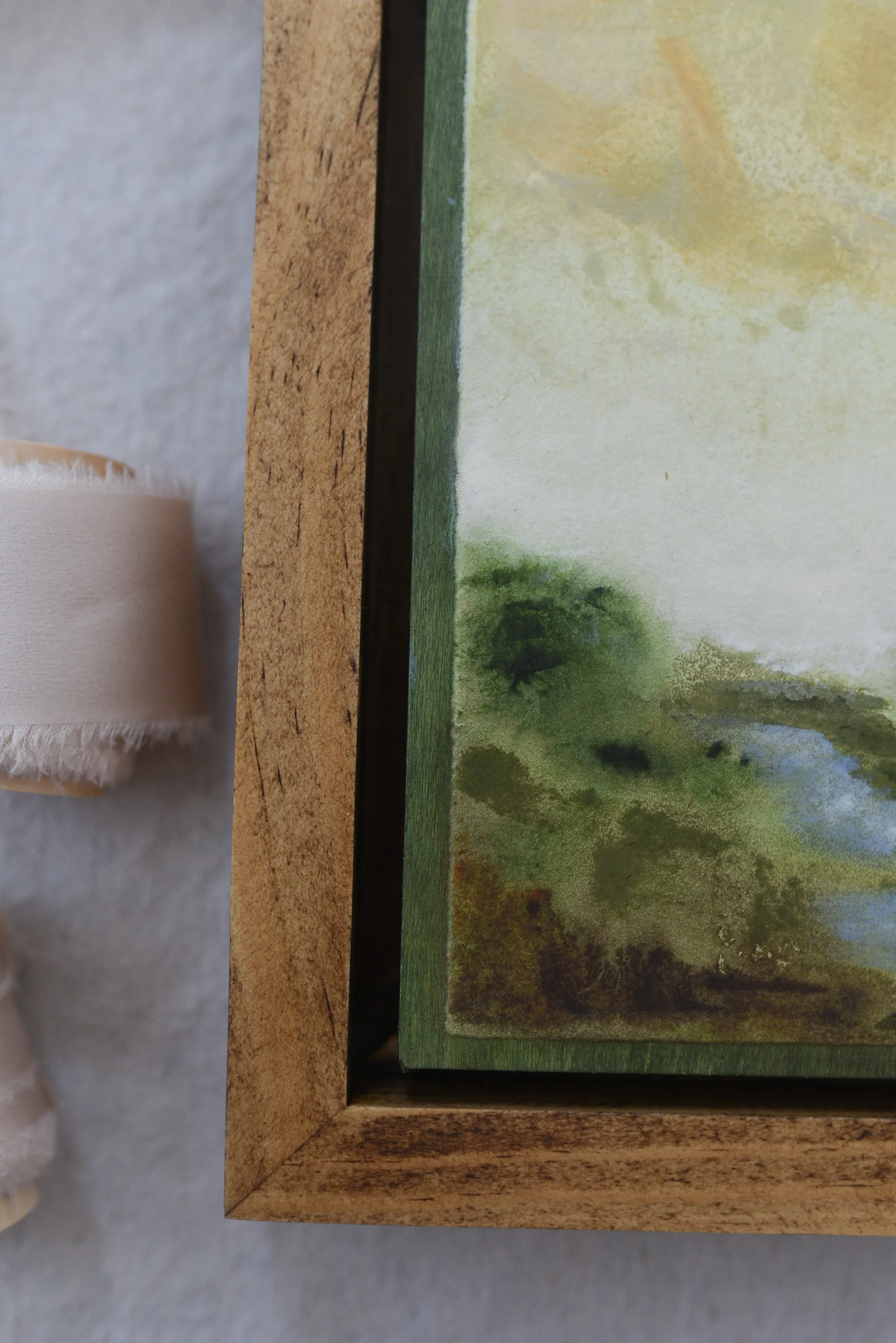Whispering Stream, view 8 of 9: A moody scene of deep greens contrasted by a soft yellow sky, with a small stream gently wandering through the lush greenery.