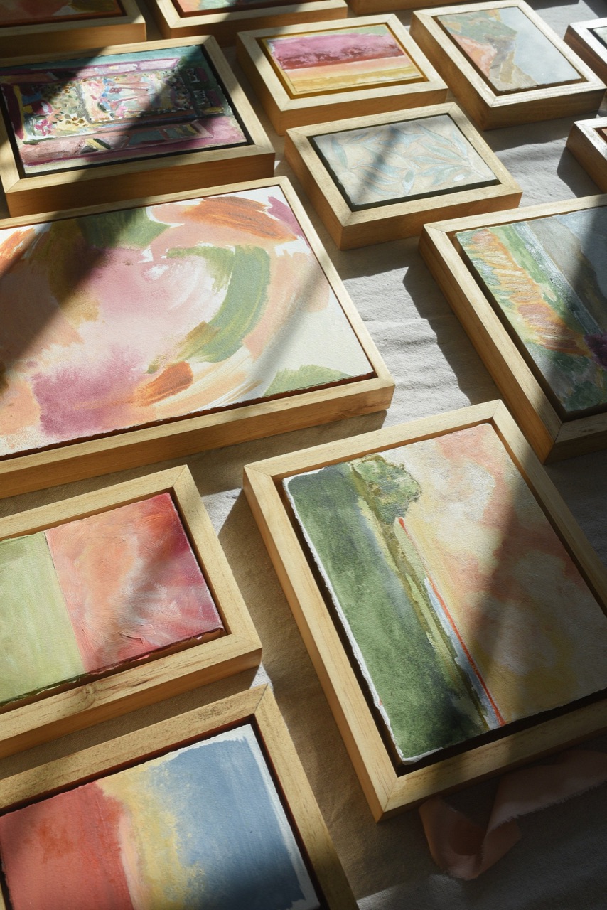McKenna's floral paintings gathered together in a sunlit studio.